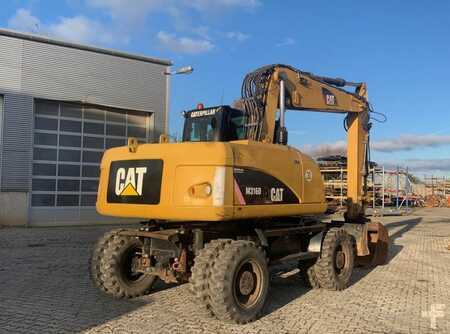 Pelle sur pneus 2010 Caterpillar 316 (1)