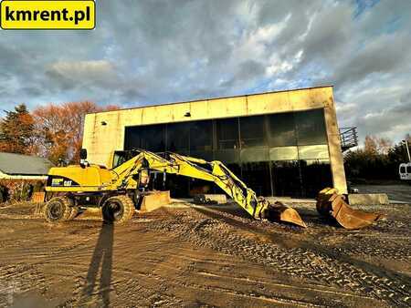 Pelle sur pneus 2005 Caterpillar M313C (1)