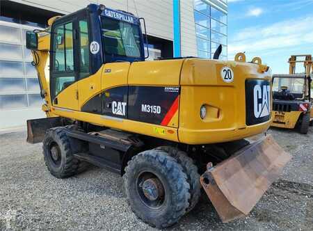 Pelle sur pneus 2009 Caterpillar M315D (1)